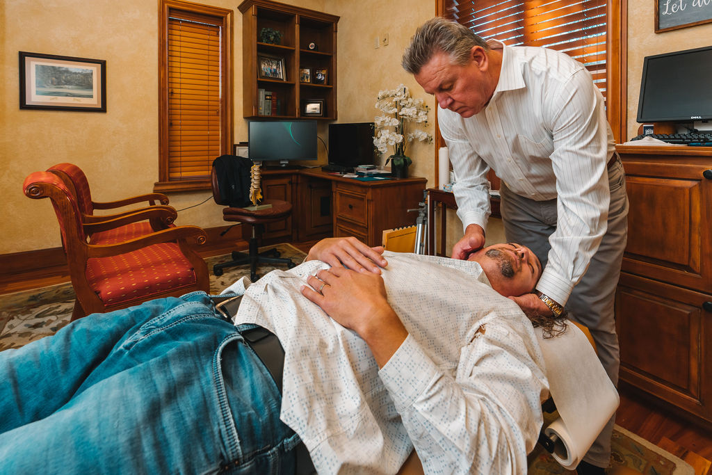 Dr. Kim Etheredge treats a neck pain patient in The Villages via chiropractic adjustment